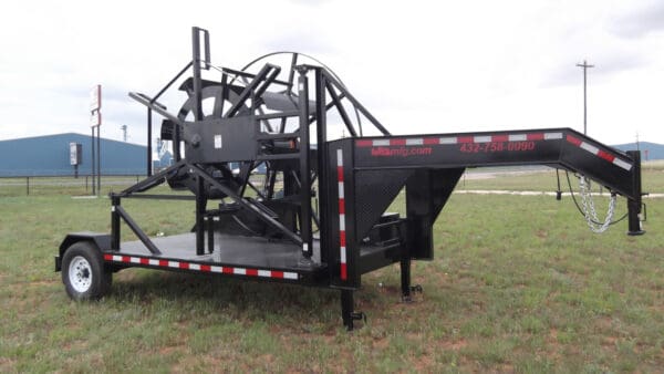 A black trailer with a large metal frame.