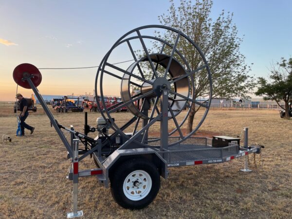 A large metal hose reel attached to a trailer.