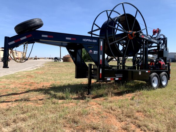 A large black trailer with a hose attached to it.