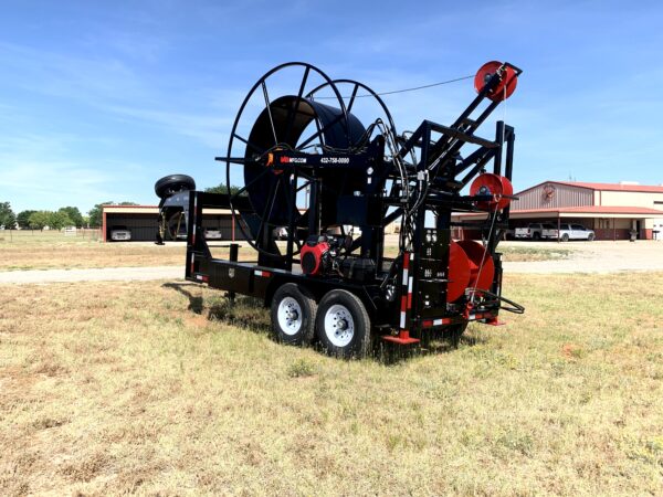 A large machine is parked in the grass.