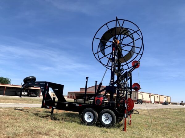 A large black and red trailer with a windmill on it.