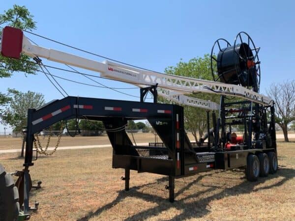 A large crane sitting on top of a trailer.