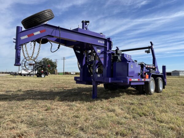 A purple trailer with a tire swing attached to it.