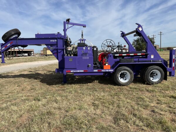 A purple truck is parked in the grass.