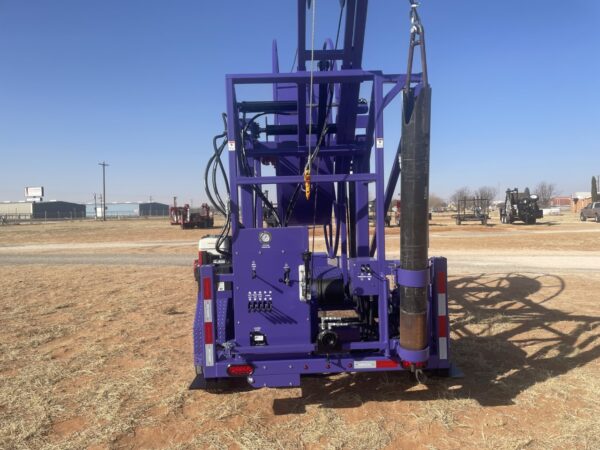 A purple truck with a crane on the back.