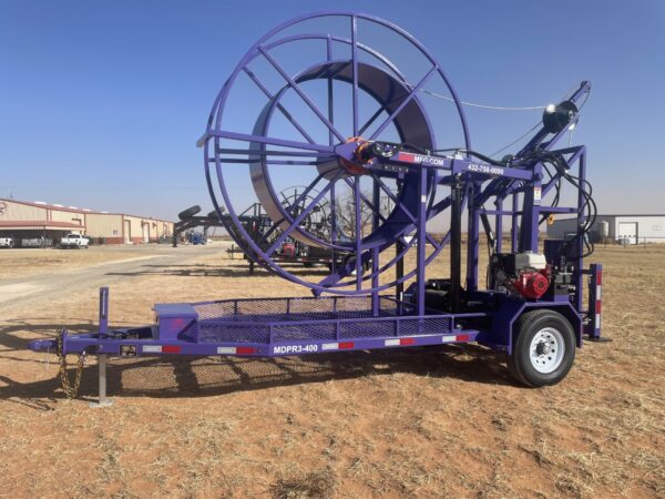 A purple trailer with a large metal wheel.