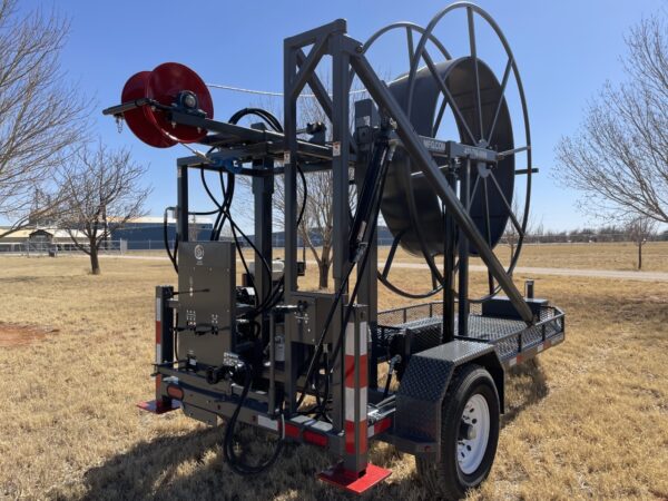 A large machine is parked in the grass.