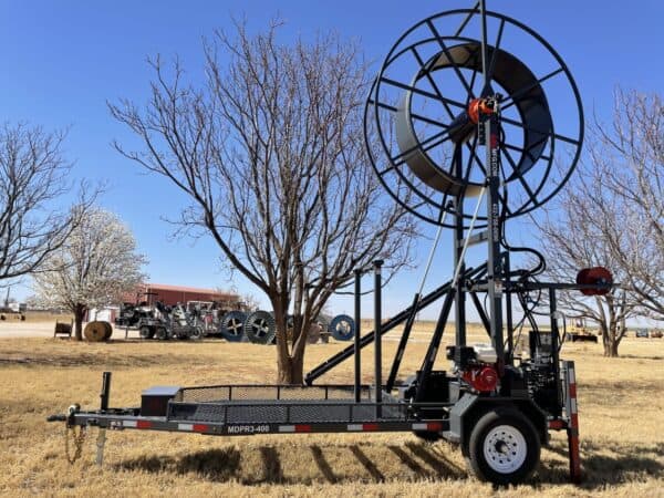 A large machine is parked in the grass.