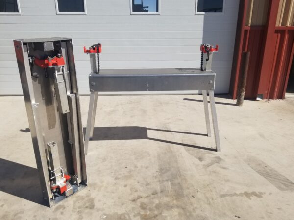 A metal bench sitting in front of a building.