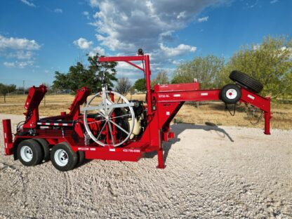 A red trailer with a large wheel on it