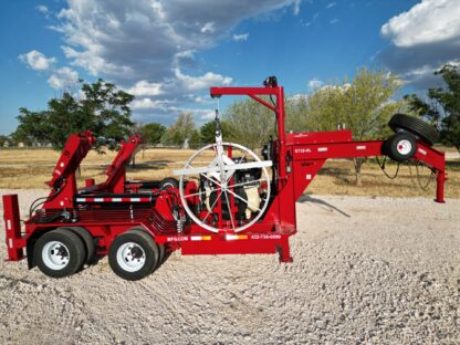 A red trailer with a large crane on it.