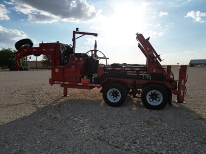 A red trailer with a crane on the back.