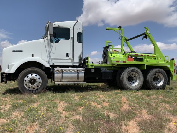 A white truck with green crane on the back