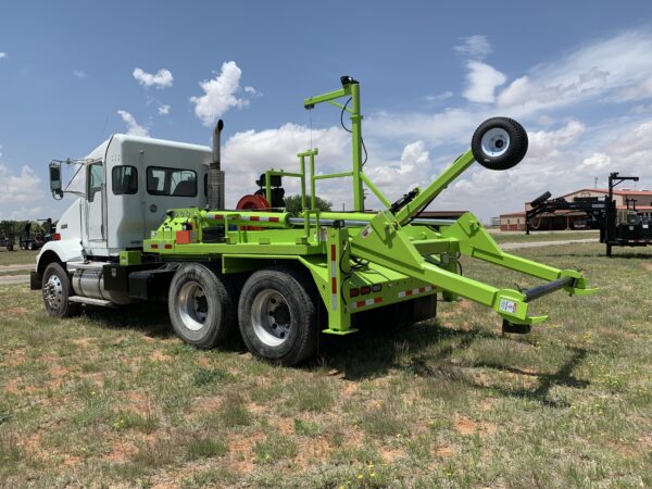 A green truck with a crane on the back