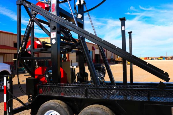 A black trailer with a crane on it