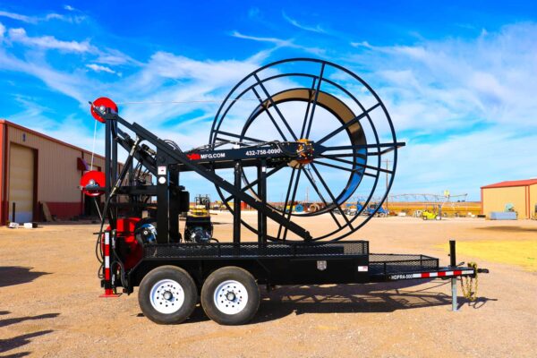 A large black and red trailer with a big wheel