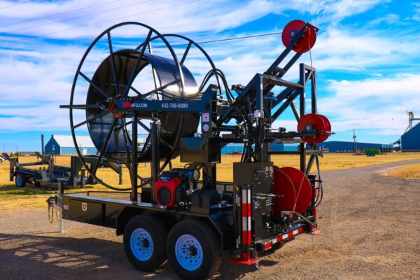 A large machine is on the ground near some grass.