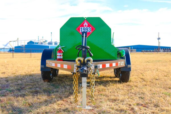 A green trailer with chains attached to it.