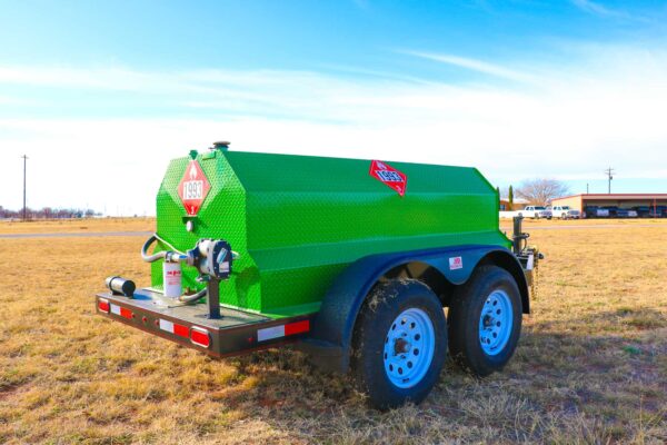 A green trailer with a red and white sign on it.