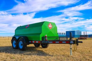 A green trailer with a large tank on it