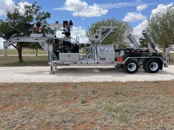 A large truck with a trailer on the side of it.