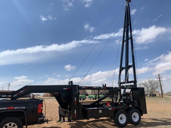 A crane is being used to lift a truck.