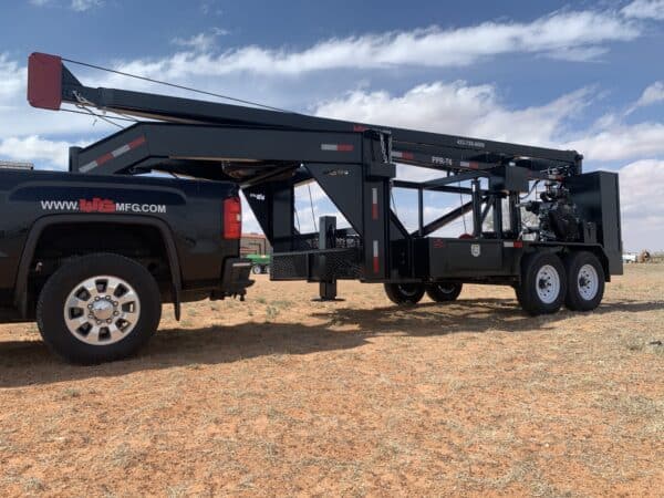 A black truck with a trailer attached to it