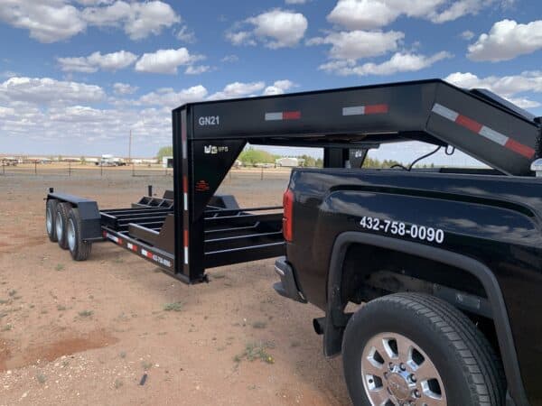 A black truck with a trailer attached to it