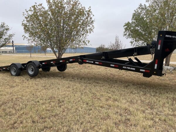 A trailer that is sitting in the grass.