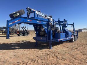 A blue trailer with a large crane on it.