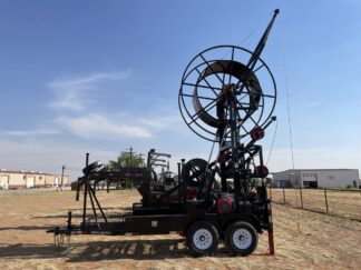 A large machine on the ground near some sand.