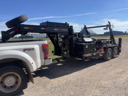 A white truck with a crane on the back of it.