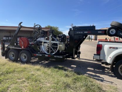 A truck with a trailer full of junk on the back.