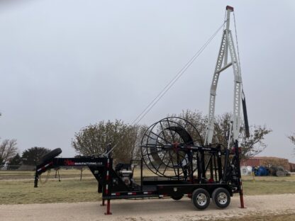 A large crane is attached to the back of a trailer.