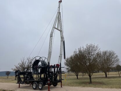 A crane that is attached to the back of a trailer.