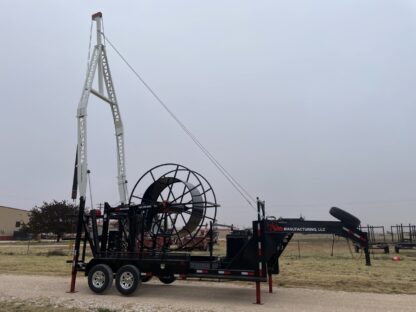 A large crane is attached to the back of a trailer.