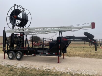 A large black crane on the back of a trailer.