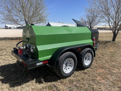 A green trailer with a black tank on it