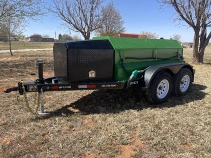 A green trailer with a black tank on it