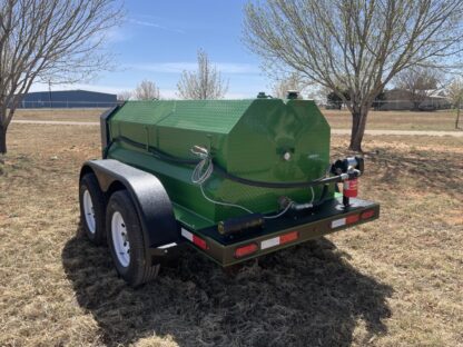 A green trailer with a tank attached to it.