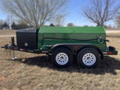 A green trailer with a black tank on it