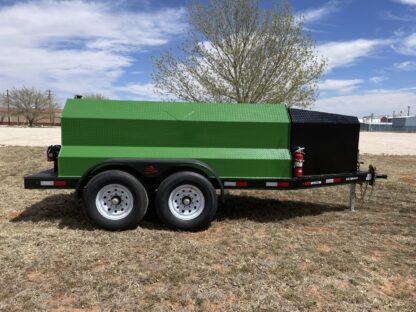 A green trailer with black tarp on the back.