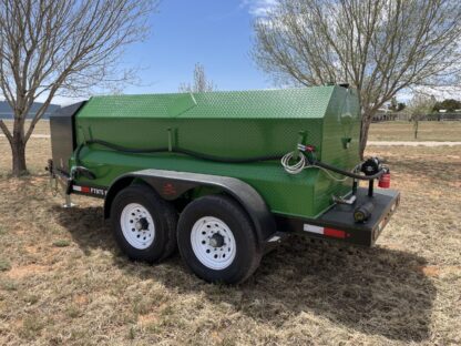 A green trailer with a tarp on the back.