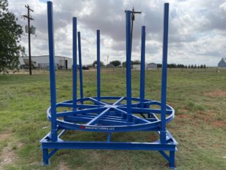 A blue metal structure in the middle of a field.