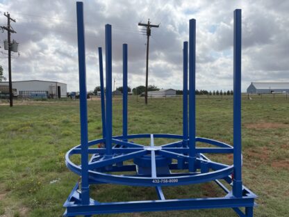 A blue metal structure in the middle of a field.