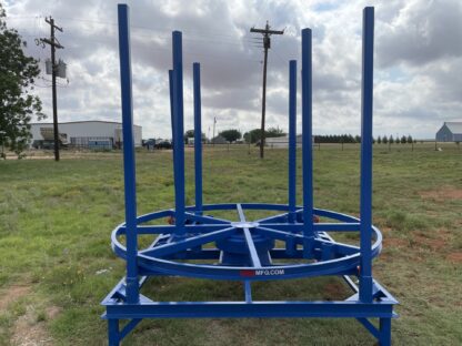 A blue metal structure in the middle of a field.