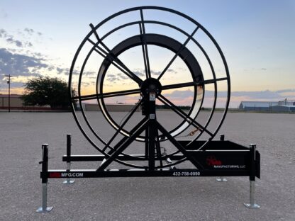 A large black wheel sitting on top of concrete.