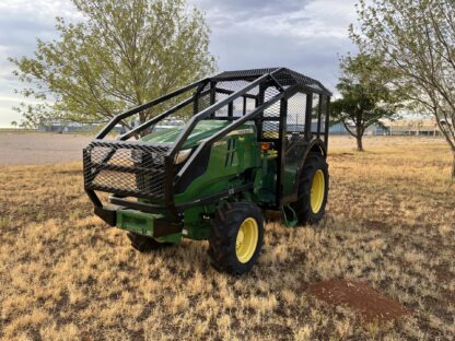 A tractor with a cage on the back of it.