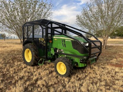 A green tractor is parked in the grass.