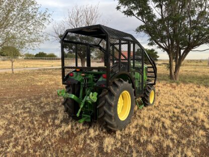 A tractor with a cage on the back of it.